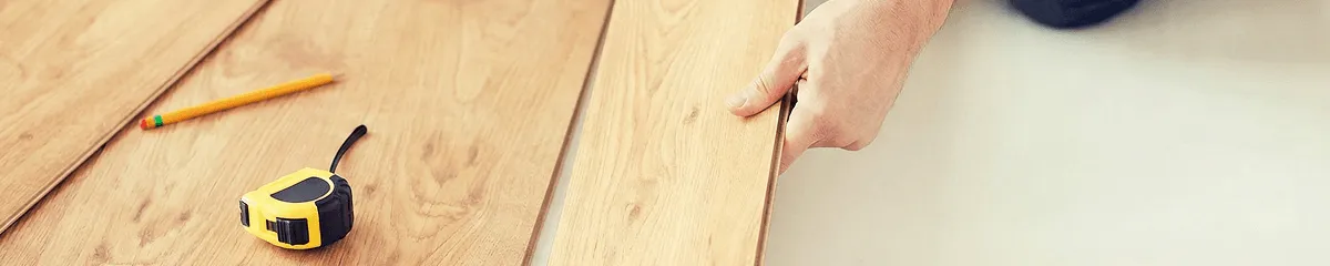 A professional installing wood flooring in Indianapolis, IN