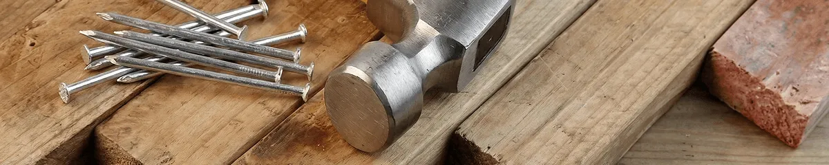 Hammer and nails on hardwood flooring boards in Indianapolis, IN